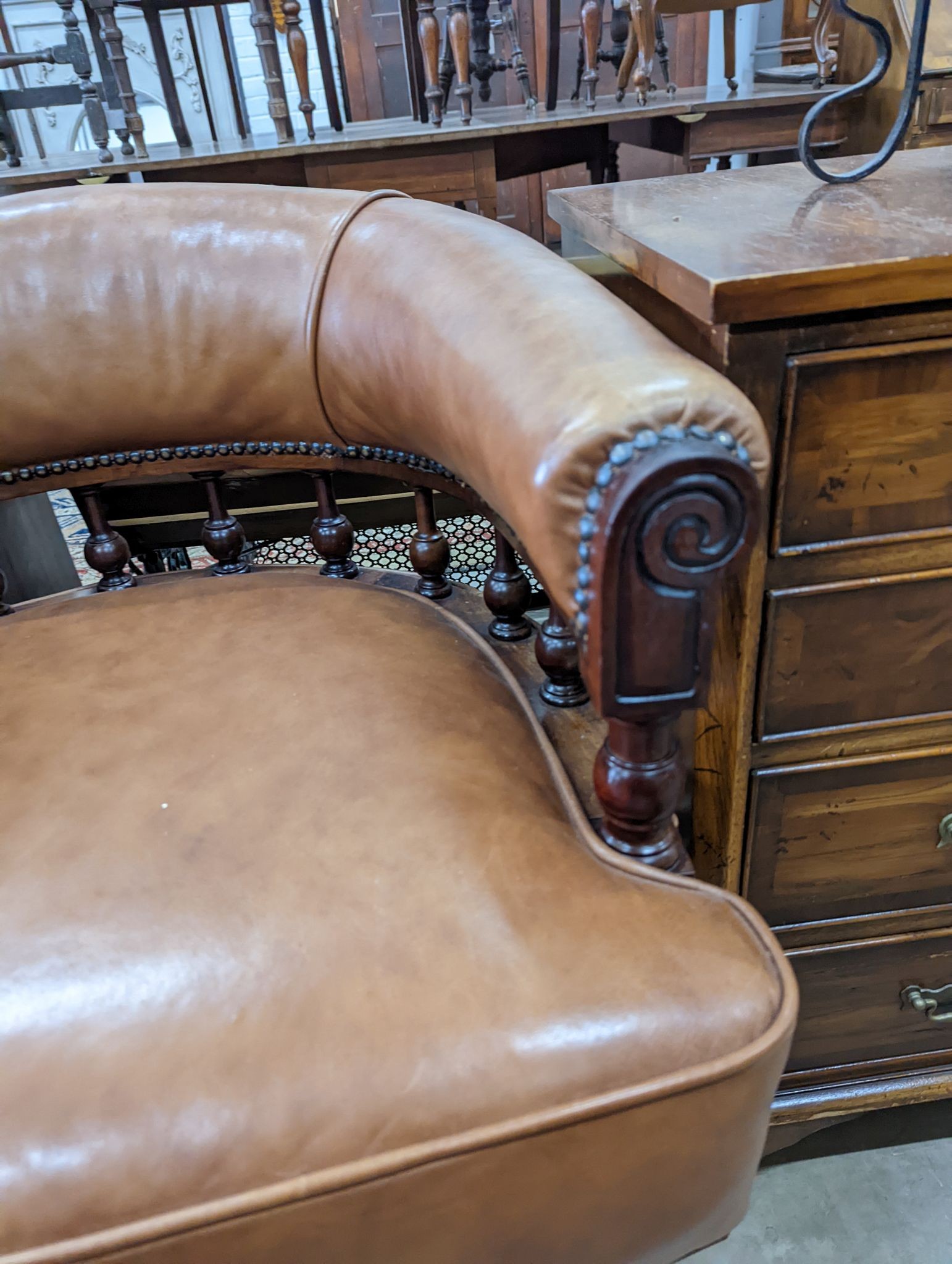 A late Victorian mahogany and tan leather swivel desk chair, width 68cm, depth 63cm, height 77cm